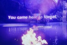 image of a fire on water with ancient ruins in the background